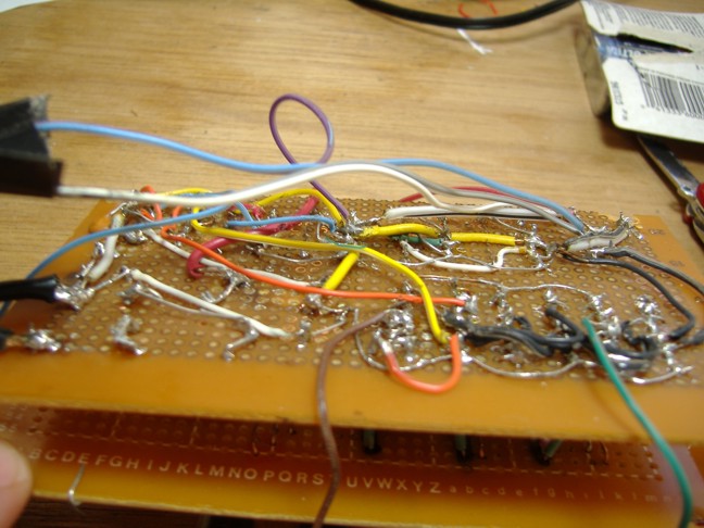 A picture of tangled wiring on the back of the clock's circuit board.