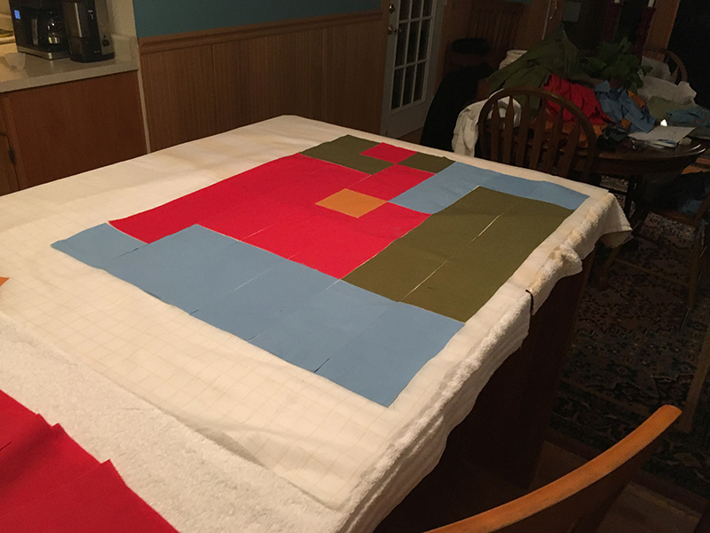 One corner of the quilt layout is nearing completion, with Mario's foot taking shape.